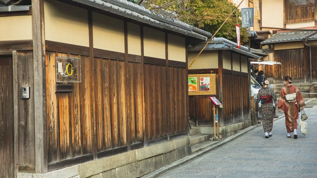 A quiet stone lane in Kyoto's geisha district at dusk
